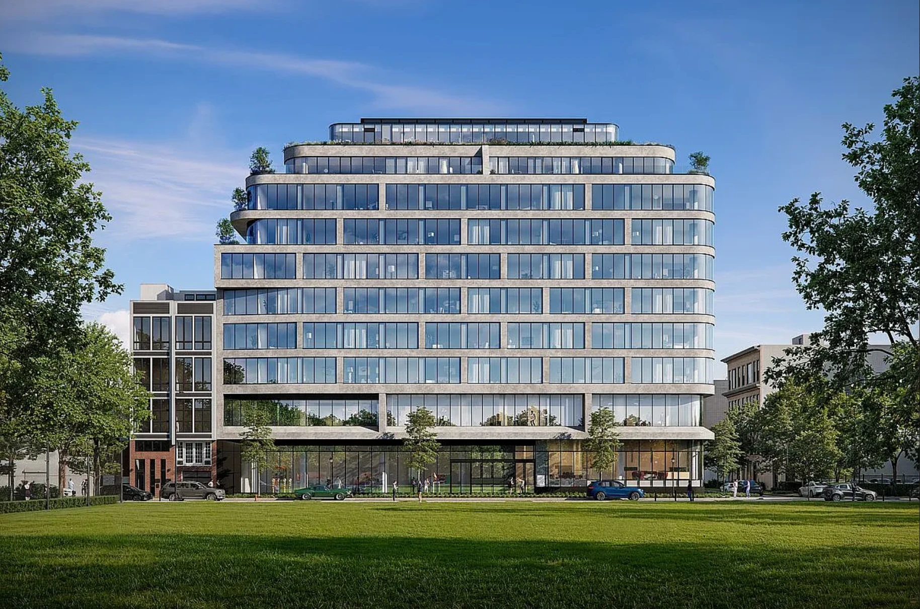 One Jones Park viewed across the park lawn, with curved glass corners and landscaped terraces